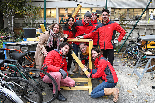 Photo: Hilti: 8 people standing next to a small wood construction