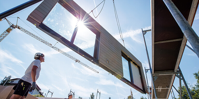 Photo: Hilti: A person looking at a wall held by a crane