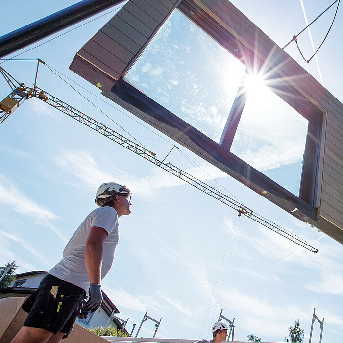 Photo: Hilti: A person looking at a wall held by a crane