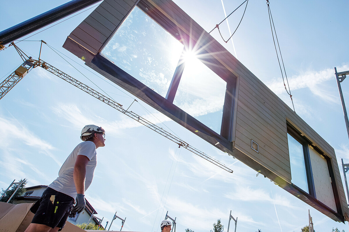 Photo: Hilti: A person looking at a wall held by a crane