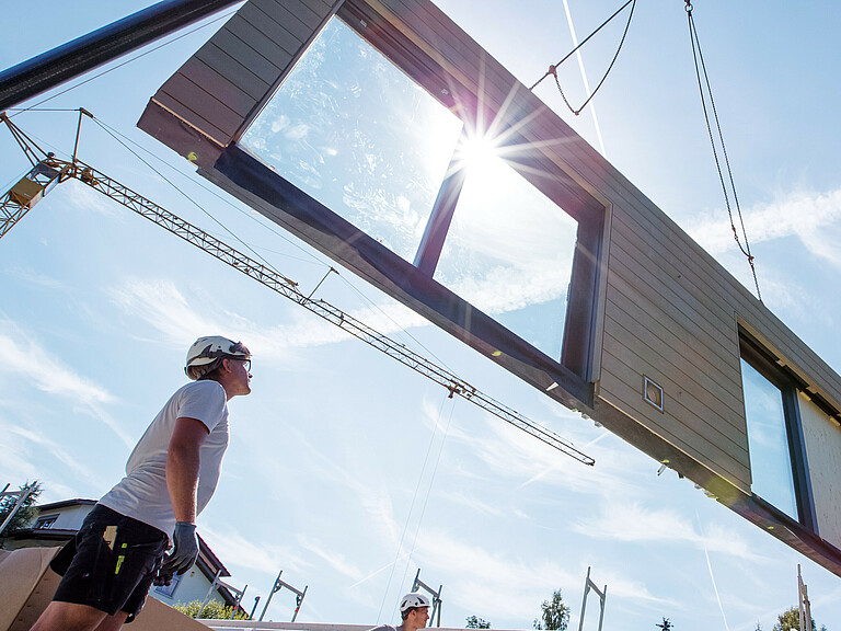 Photo: Hilti: A person looking at a wall held by a crane