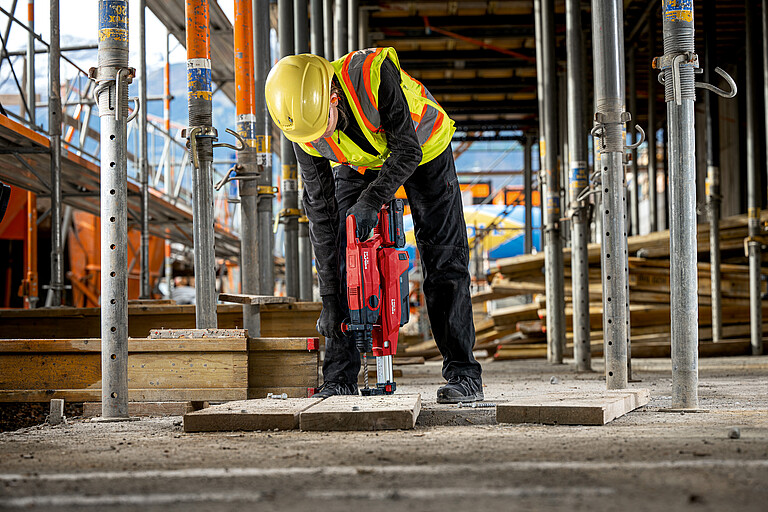 Photo: Hilti: A person working with three different Hilti gadgets 
