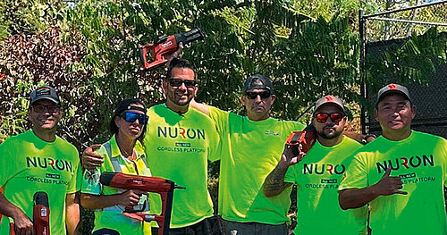 Photo: Hilti: A group of people with green NEURON shirts pose with their HILTI tools.