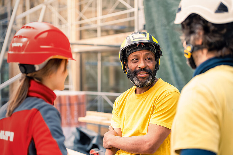 Photo: Hilti: Hilti salesperson on jobsite talking to construction workers