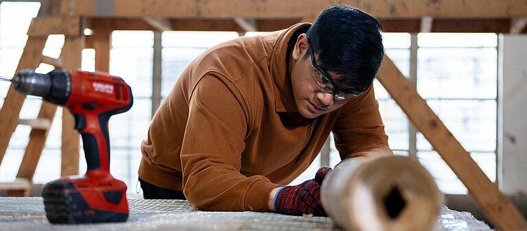 Photo: Hilti: Man preparing a cement bamboo frame
