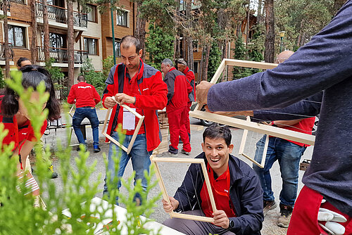 Photo: Hilti: People dressed in red on the street holding wooden frames in their hands
