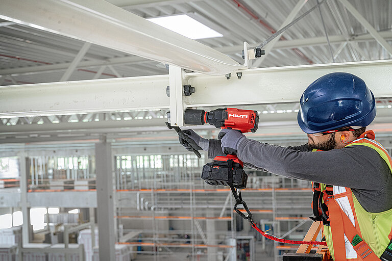 Photo: Hilti: Somebody is using a Hilti drill in a construction hall