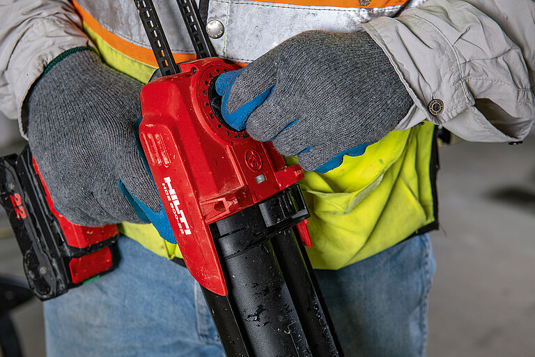 Photo: Hilti: Closeup of a red Hilti tool held by somebody