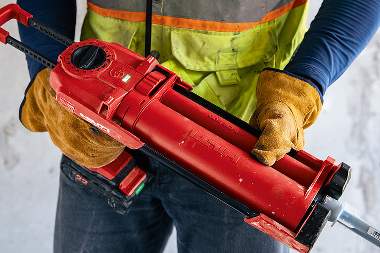Photo: Hilti: Closeup of a red Hilti tool held by somebody