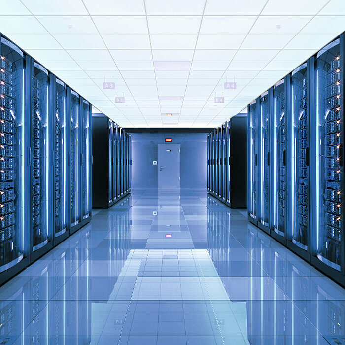 Photo: Hilti: A server room with many servers left and right and blue light