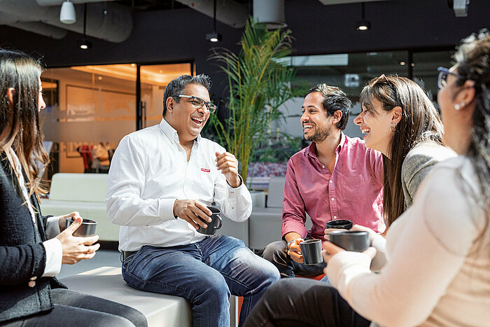 Photo: Hilti: Some people sitting in a lobby with cups in their hands talking
