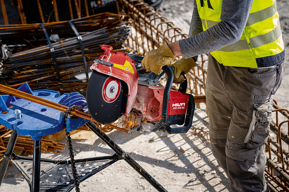 Photo: Hilti: Somebody is holding the Hilti saw cutting metal