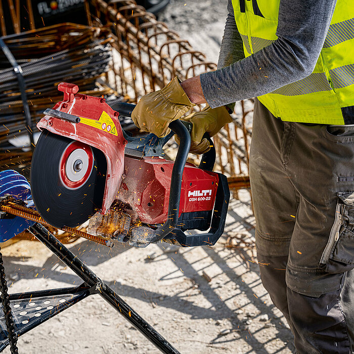 Photo: Hilti: Somebody is holding the Hilti saw cutting metal