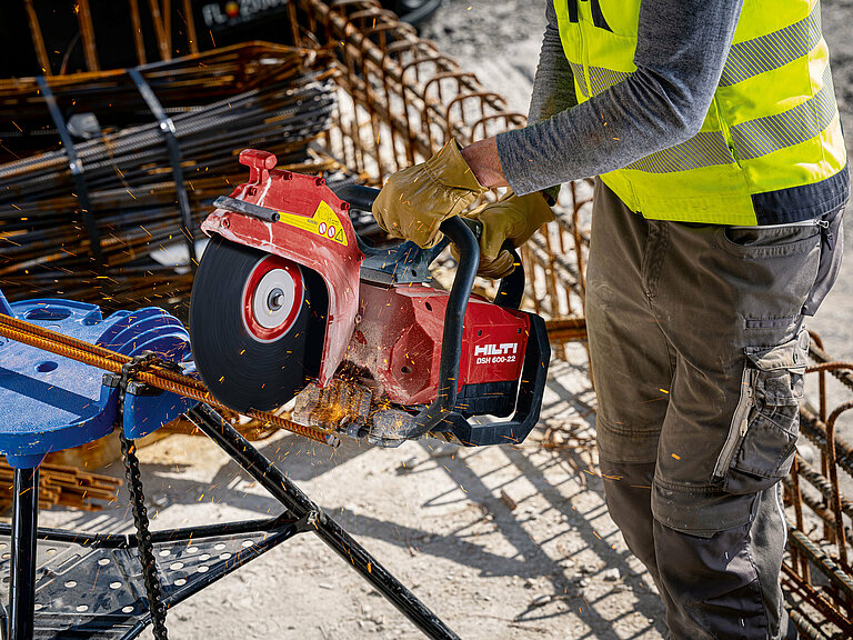 Photo: Hilti: Somebody is holding the Hilti saw cutting metal