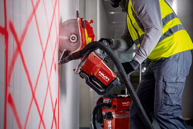 Photo: Hilti: A man using the Hilti saw to cut a wall
