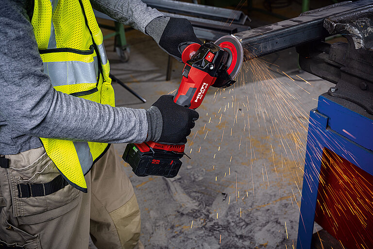 Photo: Hilti: Closeup, somebody working with a Hilti tool, cutting metal