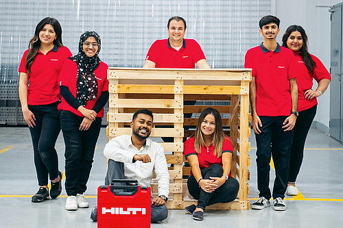 Photo: Hilti: Hilti Qatar volunteers pose next to a dog kennel with a Hilti tool case in front of them
