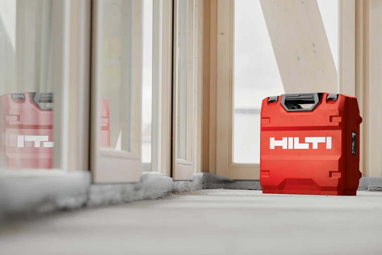Photo: Hilti: A Hilti case standing on the ground, reflection in the glass window.