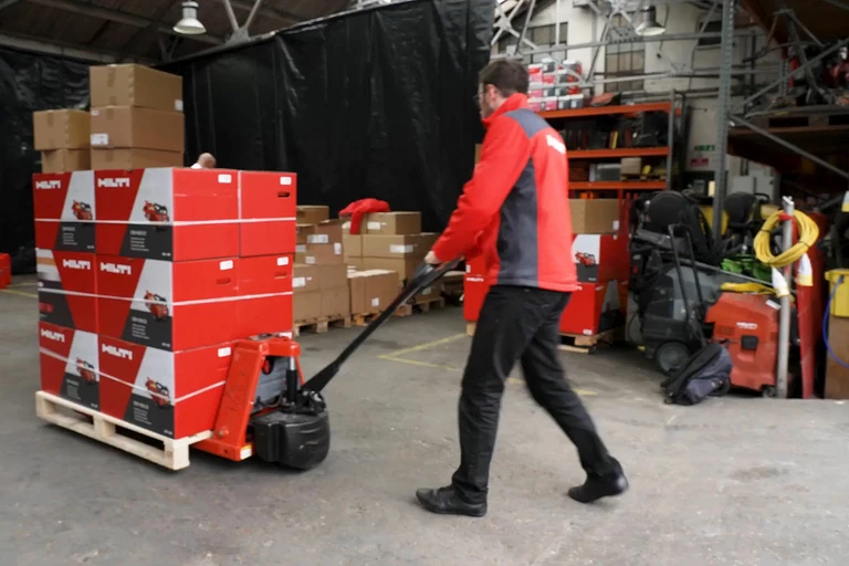 Photo: Hilti: A worker pushing a forklift with packages