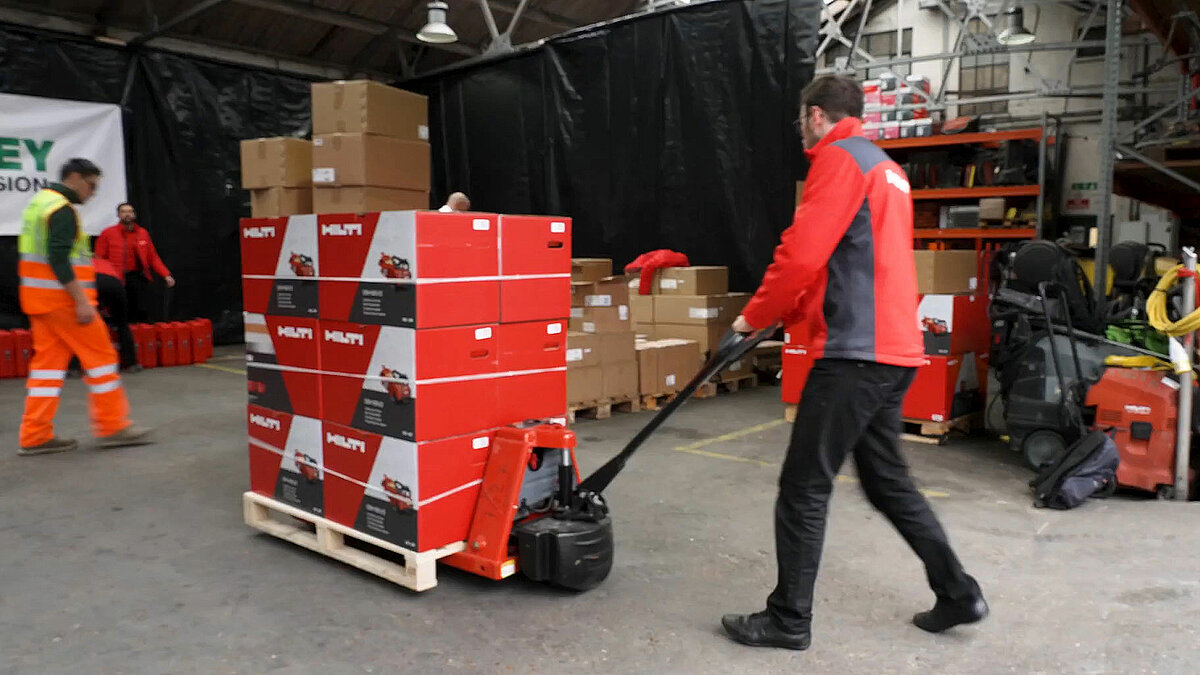 Photo: Hilti: A worker pushing a forklift with packages