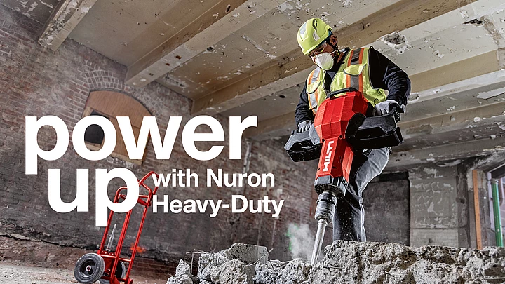 Hilti employees in red work clothes and safety glasses testing cordless solutions. 